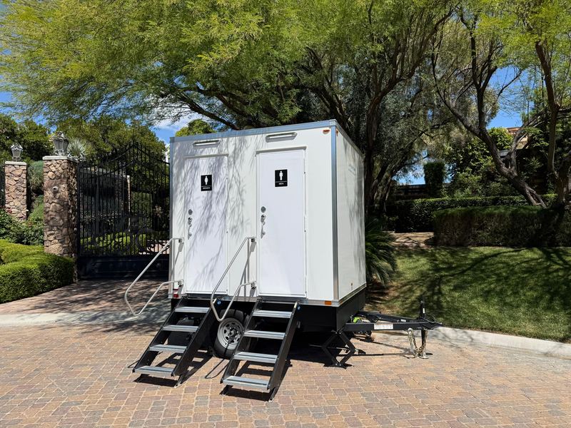 Restroom trailer on a brick driveway at a private home party